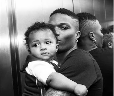 Check Out This Adorable Video Of Wizkid Teaching Zion How To Eat Pounded Yam